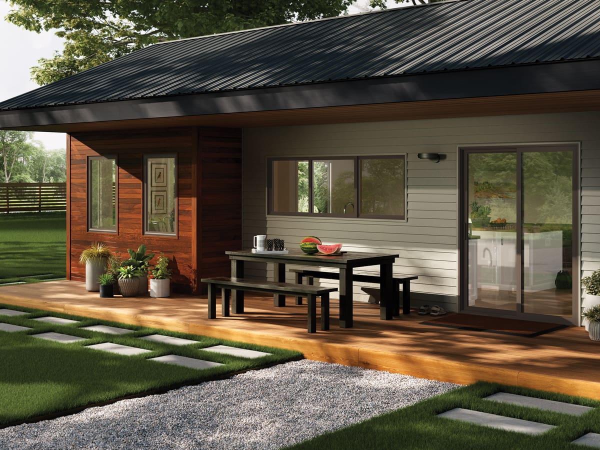 A patio with a table and chairs outside of the house.